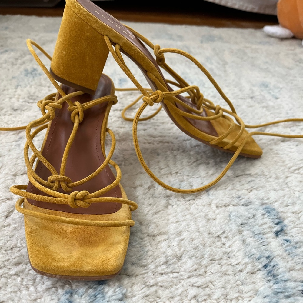 Yellow suede Alohas block heels with lace-up straps.